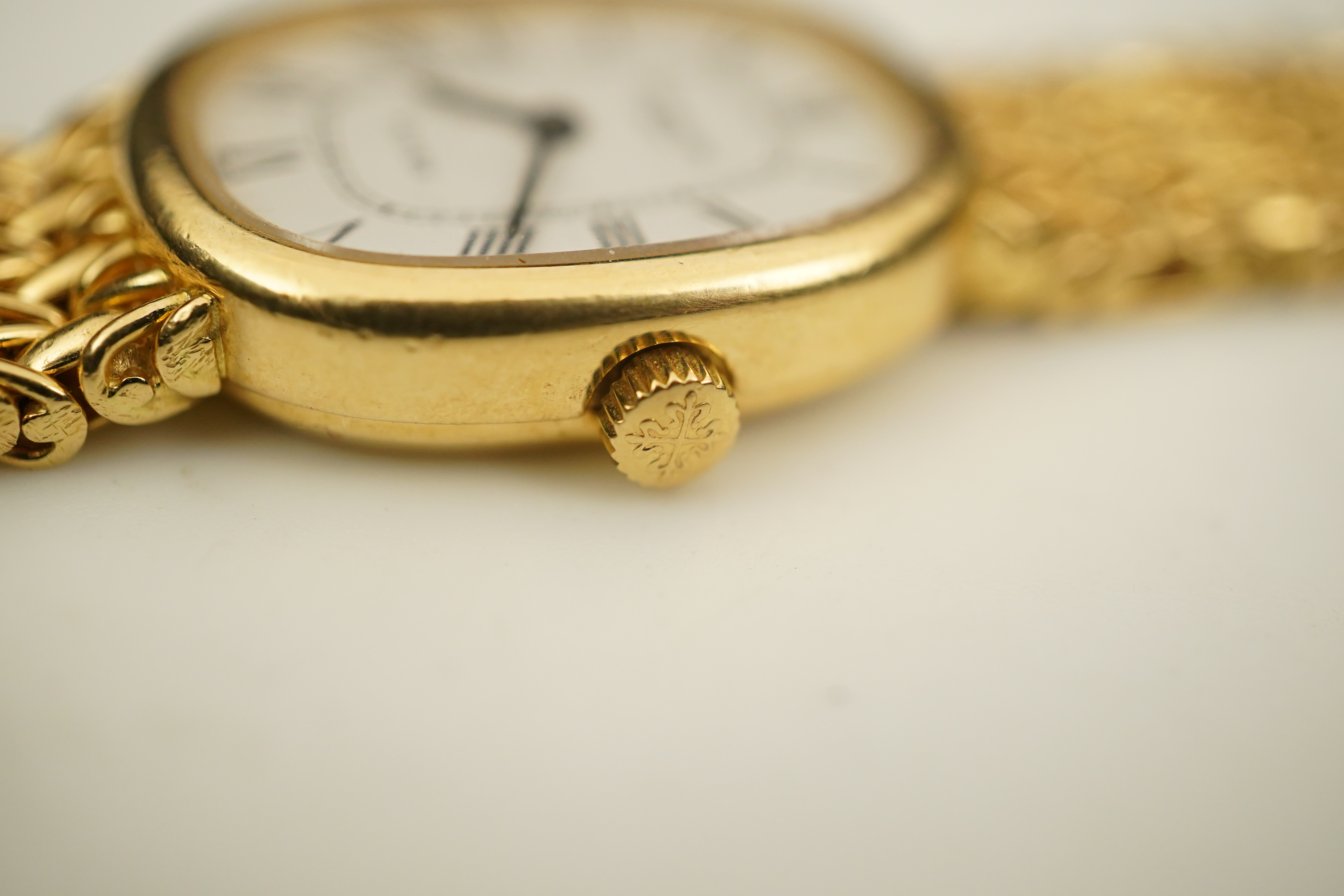 A lady's 18ct gold Patek Philippe manual wind wrist watch, on an integral 18ct gold Patek Philippe bracelet